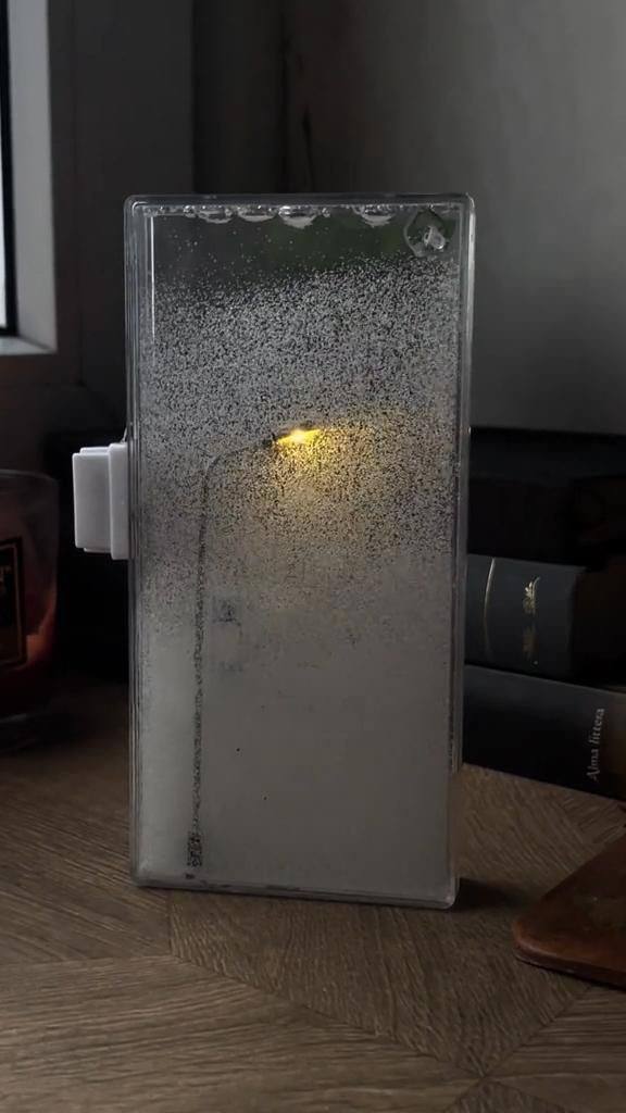 The "City Under Snow" Lightbox is a decorative LED lamp with a snowfall effect